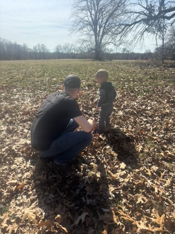 Andrew outdoors with his son